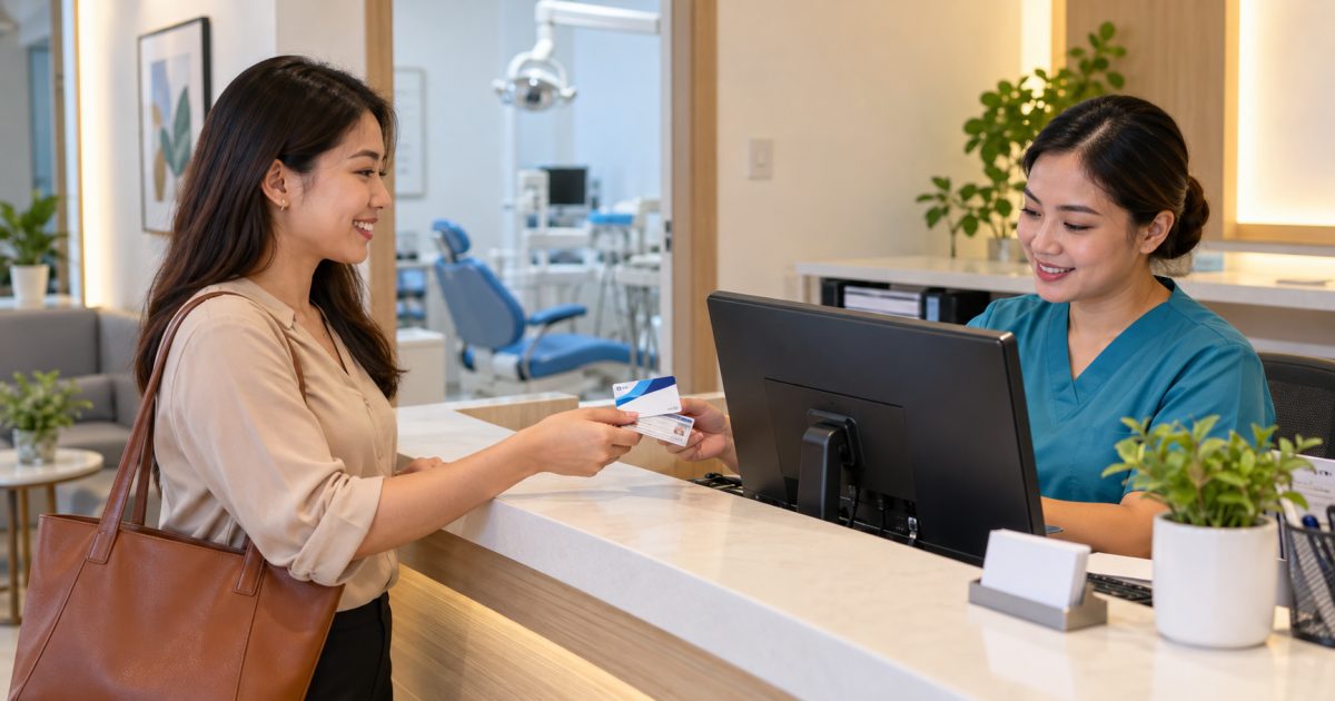 Filipino office worker presenting a health insurance card and ID to a dental clinic receptionist